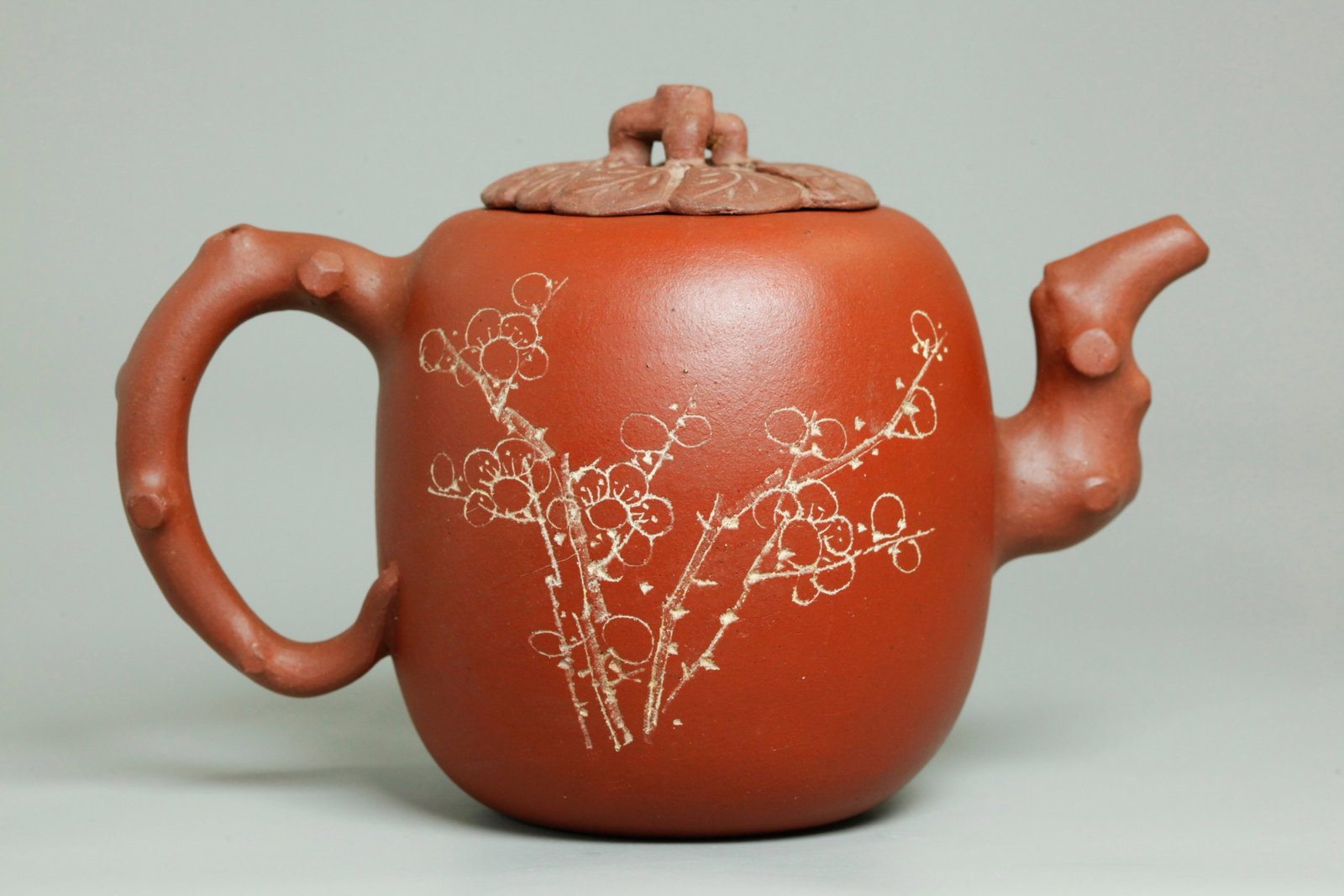 Chinese Yixing Zisha "Lizhi" Teapot & Cover: Chinese Yixing Zisha "Lizhi" Plum-shaped Teapot & Cover, the pot with smooth shaped bottom, the sides incised with flowering branches to one side and calligraphy to the reverse, with brown branch hand