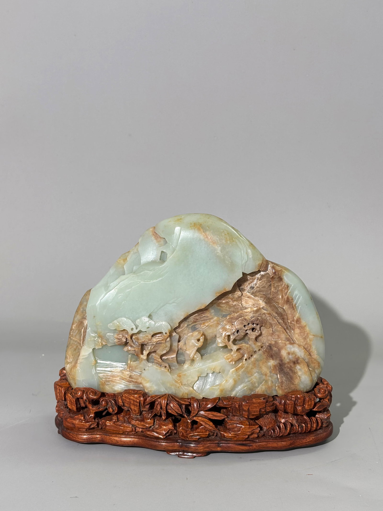 Fine Chinese Celadon Jade Scholar Mountain: Fine Chinese pale translucent celadon to pale russet part calcified Jade Scholar's Desk Mountain, carved to one side with a Man in rain hat leaving his boat at base to climb to part-hidden double Moon