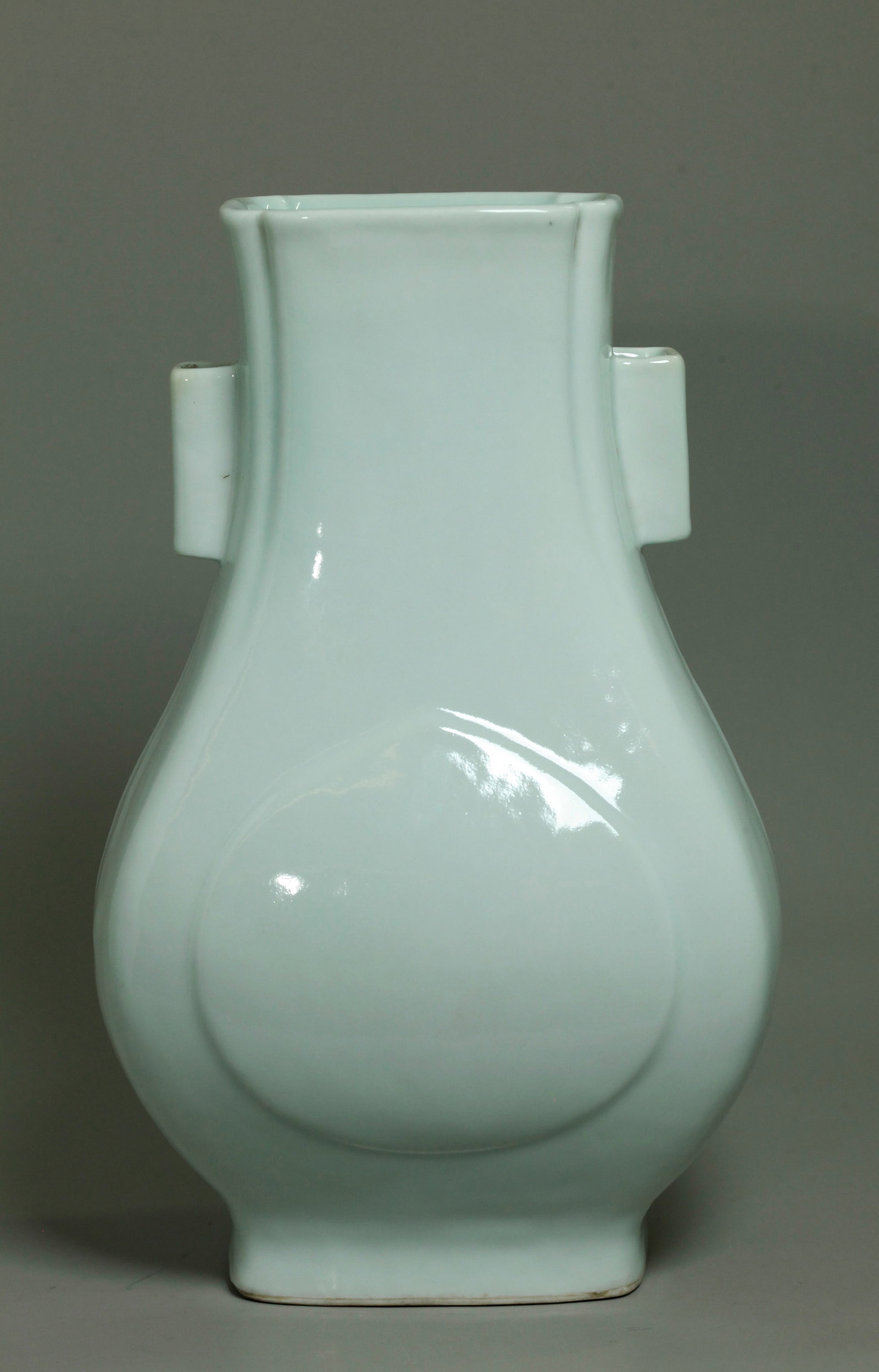 Chinese Pale Blue-White Porcelain Hu Vase: Chinese Pale Blue-White Porcelain 4 sided Hu Vase with raised "peach" shape to wider front and back and cornered tube handles to neck with flared canted corners on shorter sides, the base kiln fired a