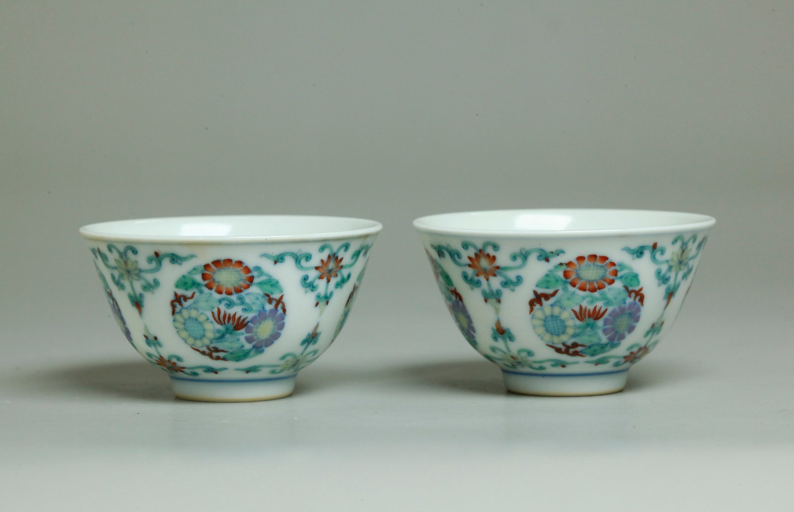 Fine Small Pair Chinese Doucai Porcelain Cups: Fine Small Pair Chinese Doucai Porcelain Cups with detailed penciled pale blue design of 4 Flower Roundels in delicate translucent enamels, the recessed bases with 6 character Youngzheng marks inside 