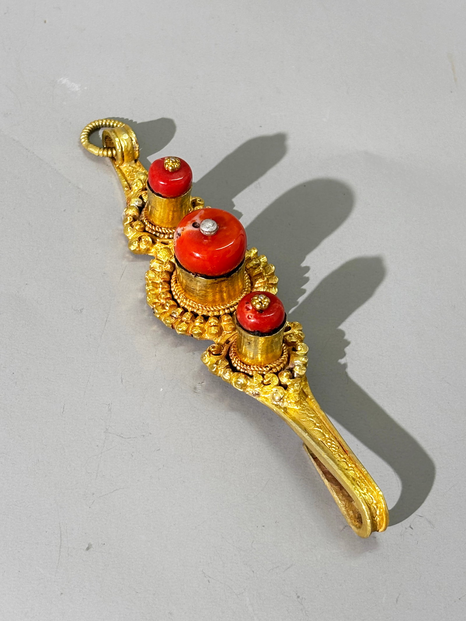Tibetan Man's Earring Gilt Metal 3 Corals; 72.7G: Large Tibetan Man's Earring in Gilt Metals & set with 3 Corals. Total weight 72.7 grams. Length 5 3/4 inches X width 1 3/8 inches. NOTE: Worn suspended at the ear but attached to hair or head gear, a 