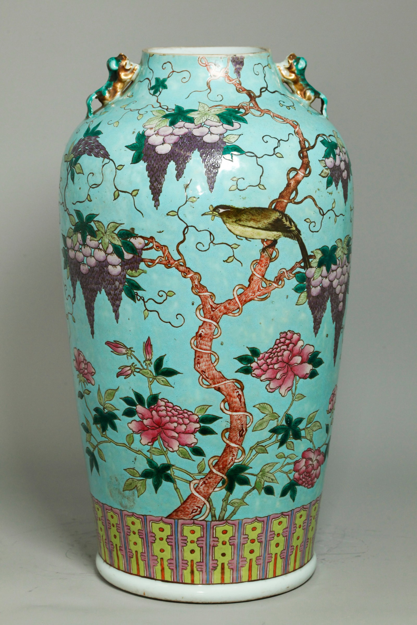 Chinese Da Ya Zhai Turquoise Porcelain Vase: Chinese Da Ya Zhai Turquoise Ground Porcelain Vase with a large black & yellow Bird to front and back in branches with flowering purple wisteria vines and pink peonies at the bottom; 2 Fu Dog Handles 