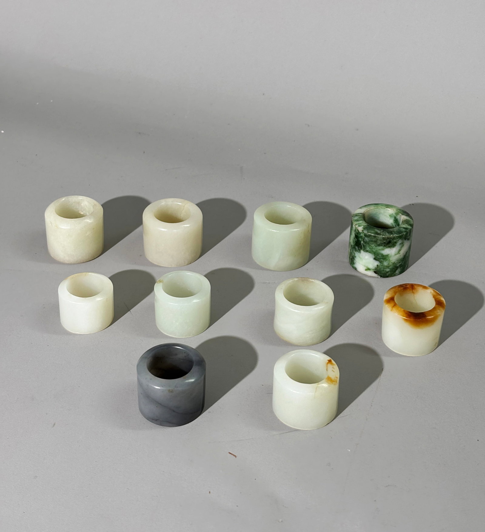 10 Chinese Qing Dynasty Jade Archer's Rings: 10 Chinese Qing Dynasty Jade Archer's Rings: 7 in warm white jade, 5 of which have slight colored inclusions, 1 with pronounced russet to curved edge, 1 in white to green jade and 1 in gray jade. Appr