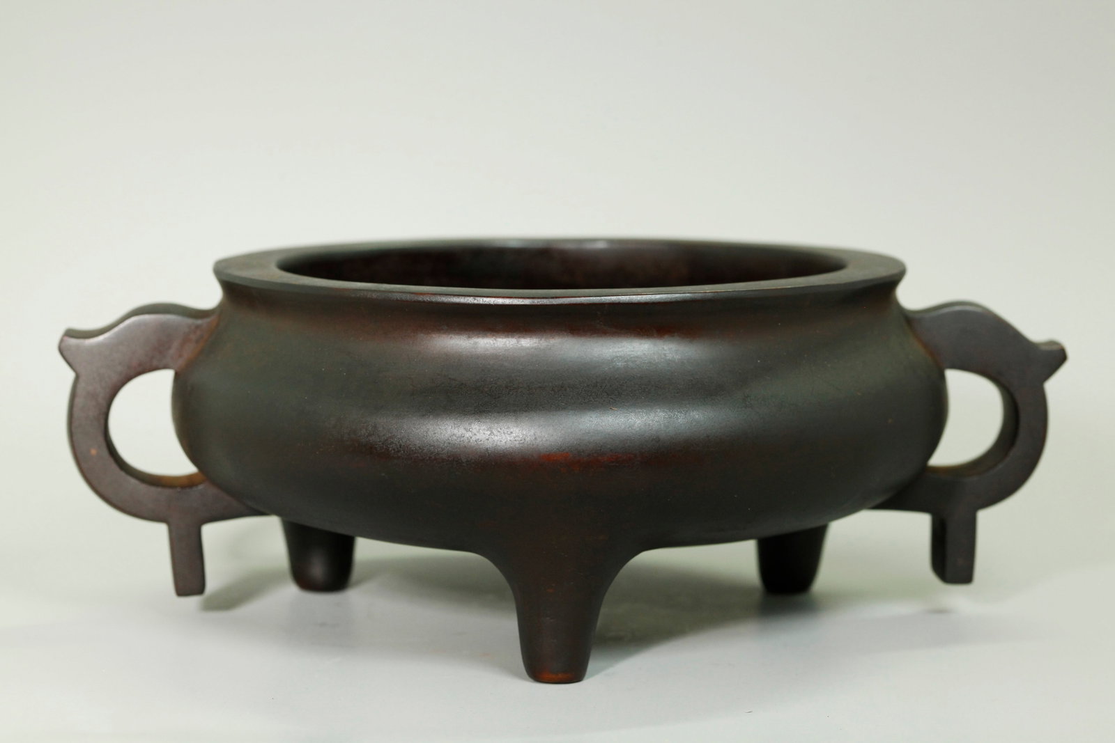 Large Chinese Bronze 3 Legged, 2 Handled Censer: Fine, large & heavy Chinese 18th/19th century Bronze 3 Legged, 2 Handled Censer, the base with a 16 character Xuande Inscription. Height 4 inches X width from handle to handle 11 1/2 inches. Total wei
