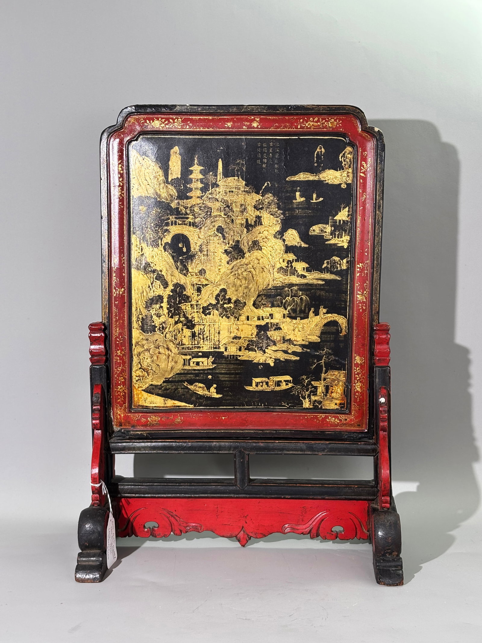 Chinese 1800 Black Red Gold Lacquer Table Screen: Chinese circa 1800 Black, Red & Gold Lacquer Table Screen; the front panel with a gold on black view of houses, pavilions and a Pagoda with Figures in a town near water with bridge and pleasure boats,