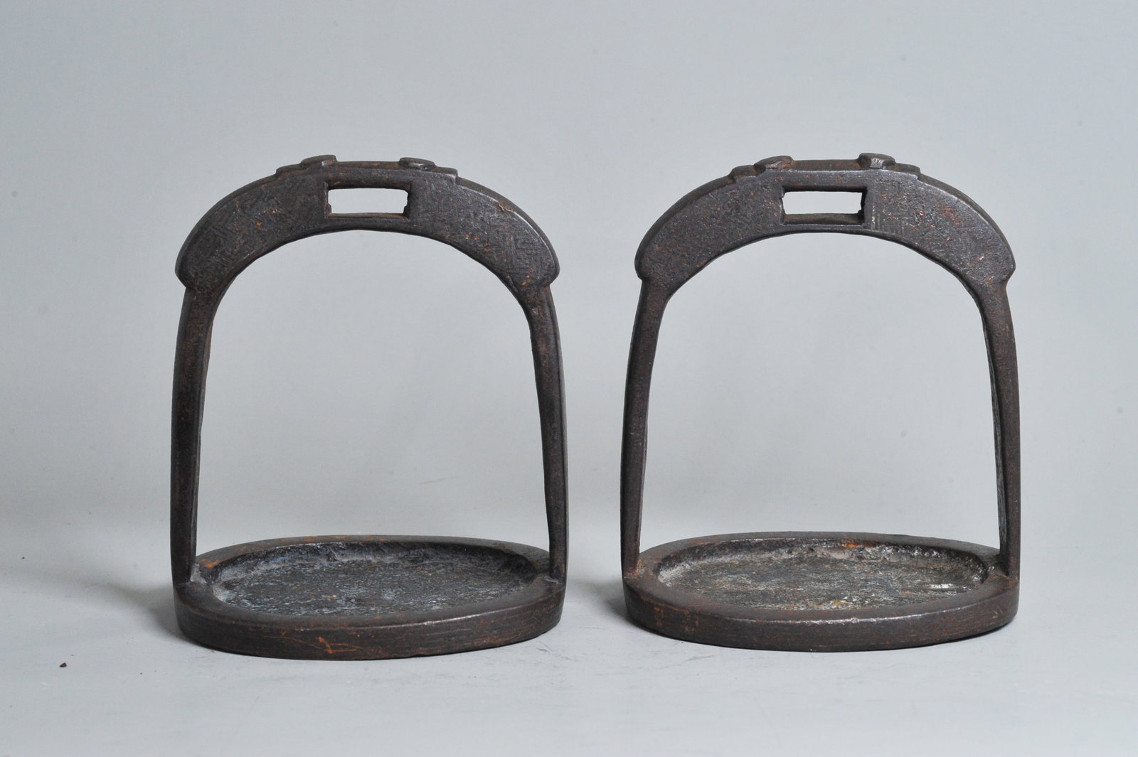Pr Chinese Ming/Qing Silver Inlaid Iron Stirrups: Pair Chinese Late Ming or Early Qing Dynasty Silver Inlaid Iron Stirrups with inlaid wire trellis designs and a wave border to base edge, further incised with small designs including fish. Height 5 1/