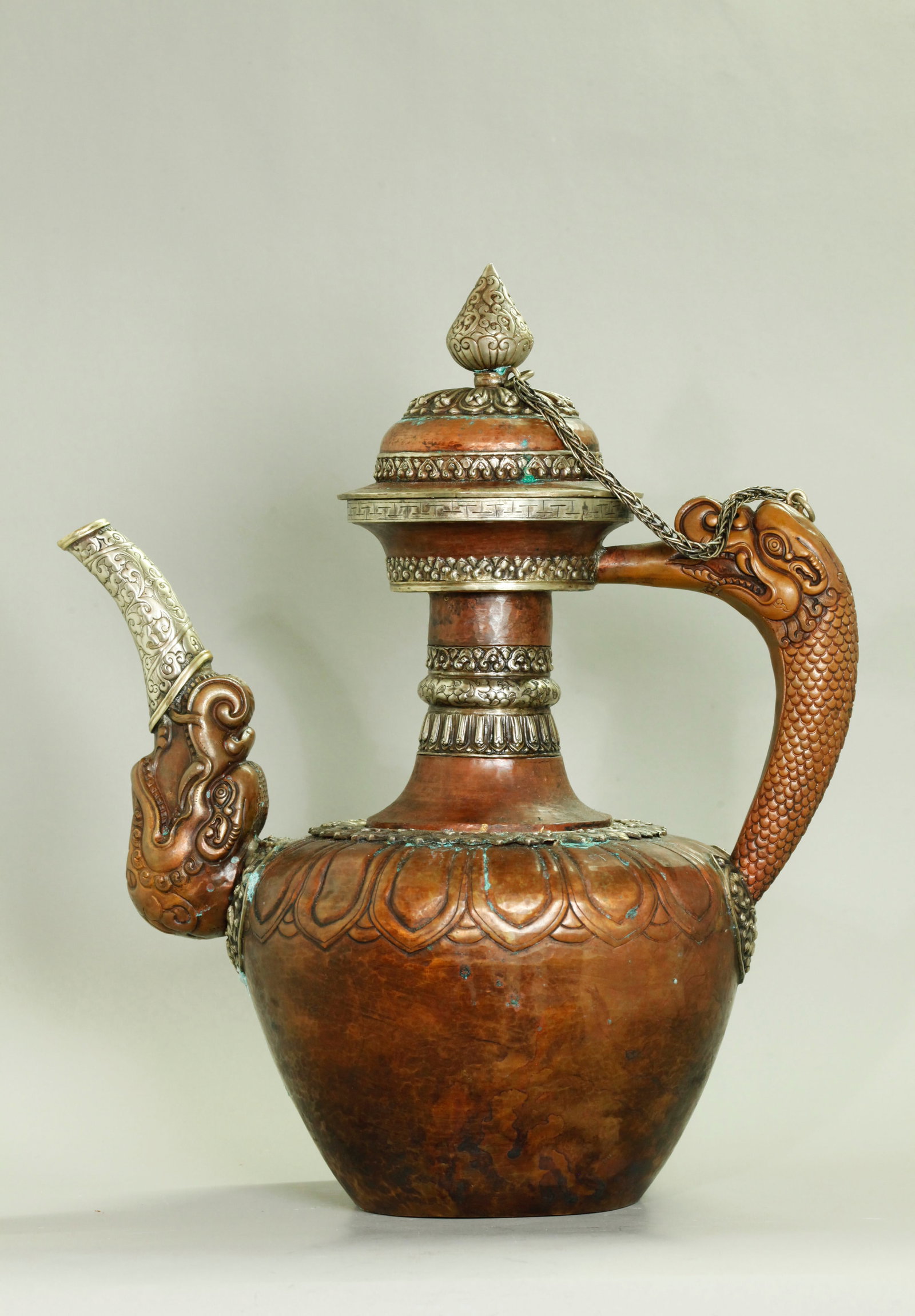 Lg Tibetan Copper & Silver Butter Po-Cha Teapot: Large Tibetan hammered copper with bands of repousse and incised Silver on a Butter Po-Cha Teapot with elaborate Dragon Head handle and spout, the cover with silver Lotus Bud finial and with a woven w