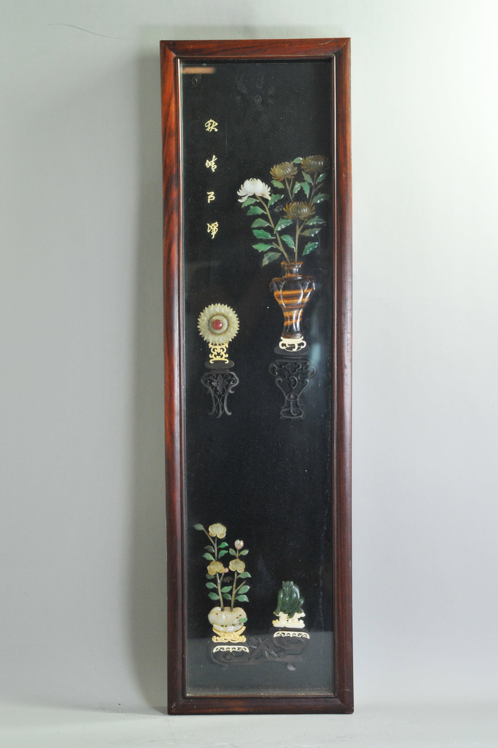 Chinese Jade & Hard Stone Wood Shadowbox Panel: Chinese antique Jade & Hard Stone applied to Lacquered Wood in a Shadowbox Panel, the carvings with flat backs and polished fronts: with a large Tiger Eye carved vase with Chrysanthemums, a carved and
