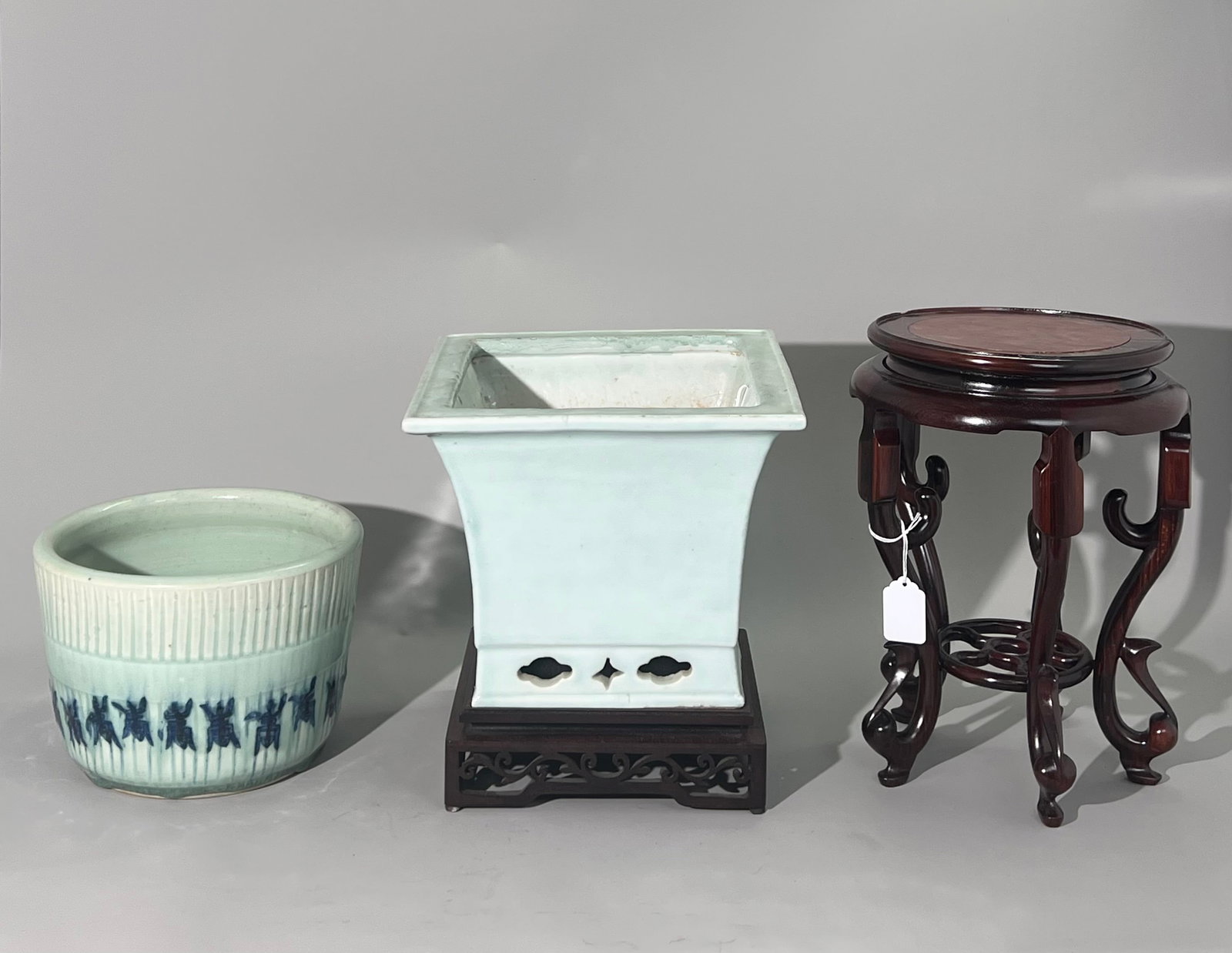 2 Chinese Qing Celadon Porcelain Planter: Chinese Qing Dynasty Pale Celadon Porcelain 4 Sided Square Planter with flaring sides over a pierced foot, the bottom unglazed with original drainage hole now with infill, with a square hard wood stan