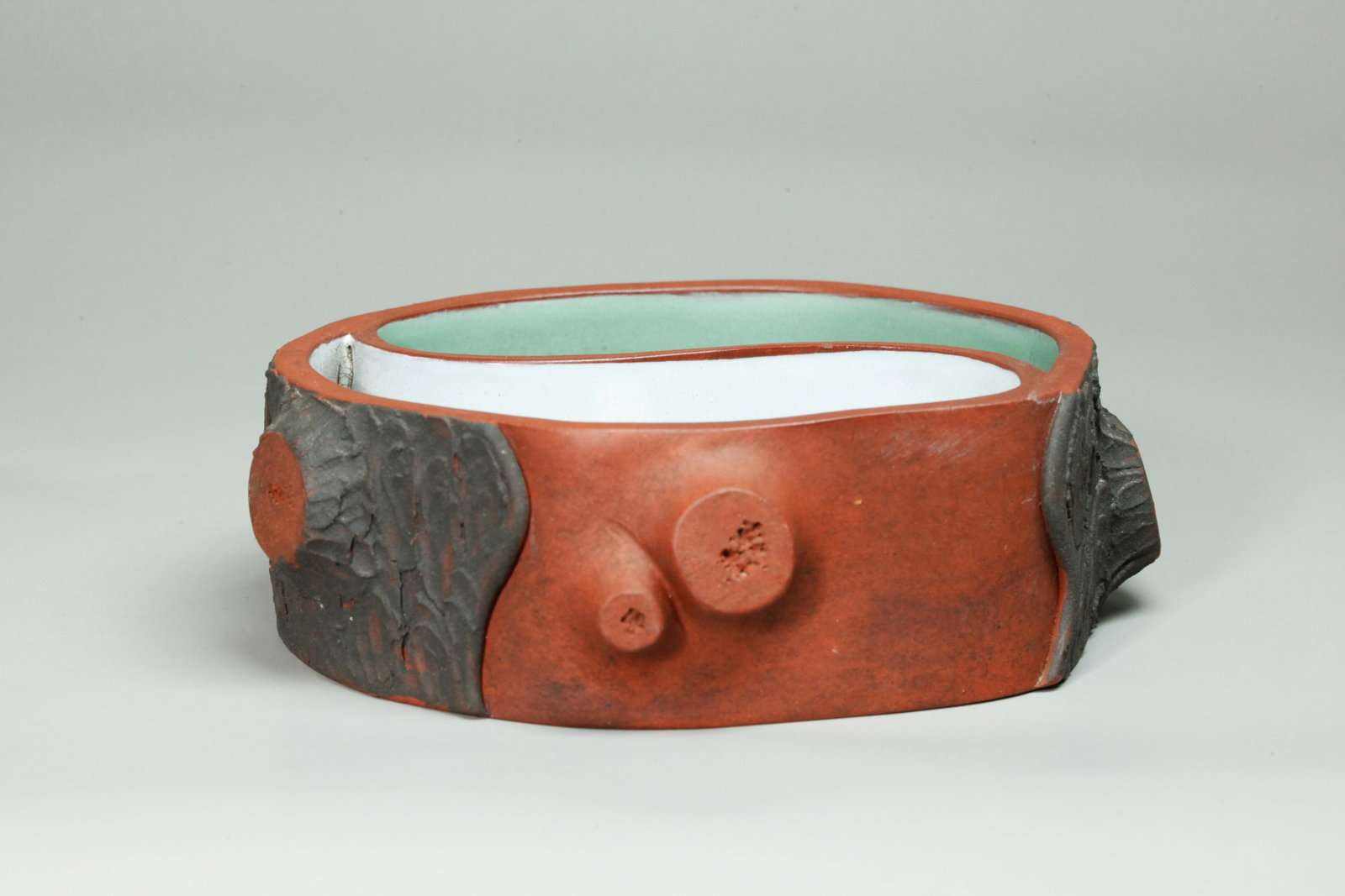 Chinese Yinyang Yixing Zisha Enameled Brush Washer: Chinese Yinyang Yixing Zisha Enameled Brush Washer, the outside formed as a tree section with dark brown clay "bark" and red clay raw wood, the inside divided as a Yinyang mark with 1/2 celadon green