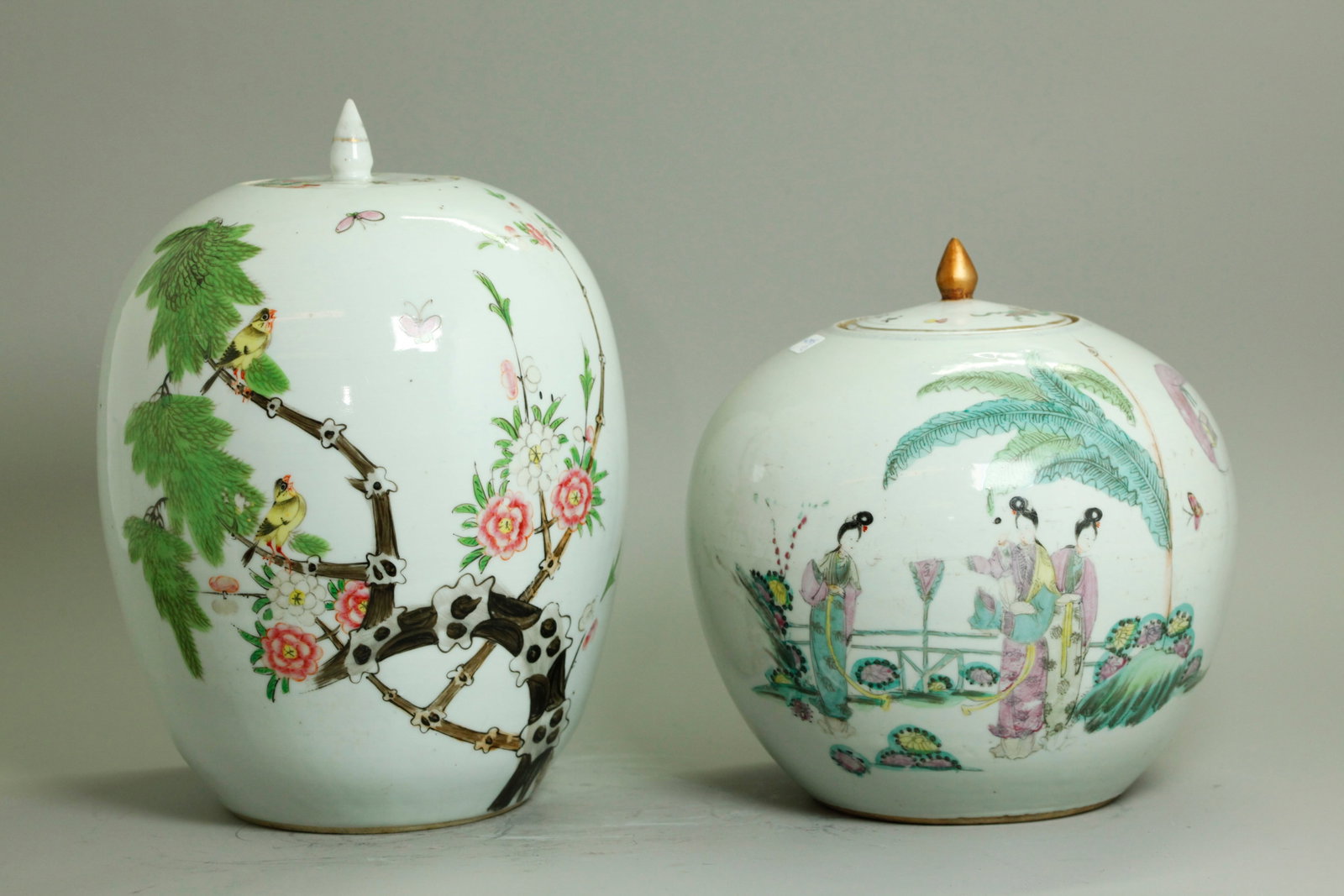 2 Chinese Qing Enameled Gourd Shape Porcelain Jars: 2 Chinese late Qing Dynasty Famille Rose enameled Porcelain Gourd-shaped covered Jars; the larger with 2 yellow birds on tree branch with other flowering branches and butterflies and the recessed base