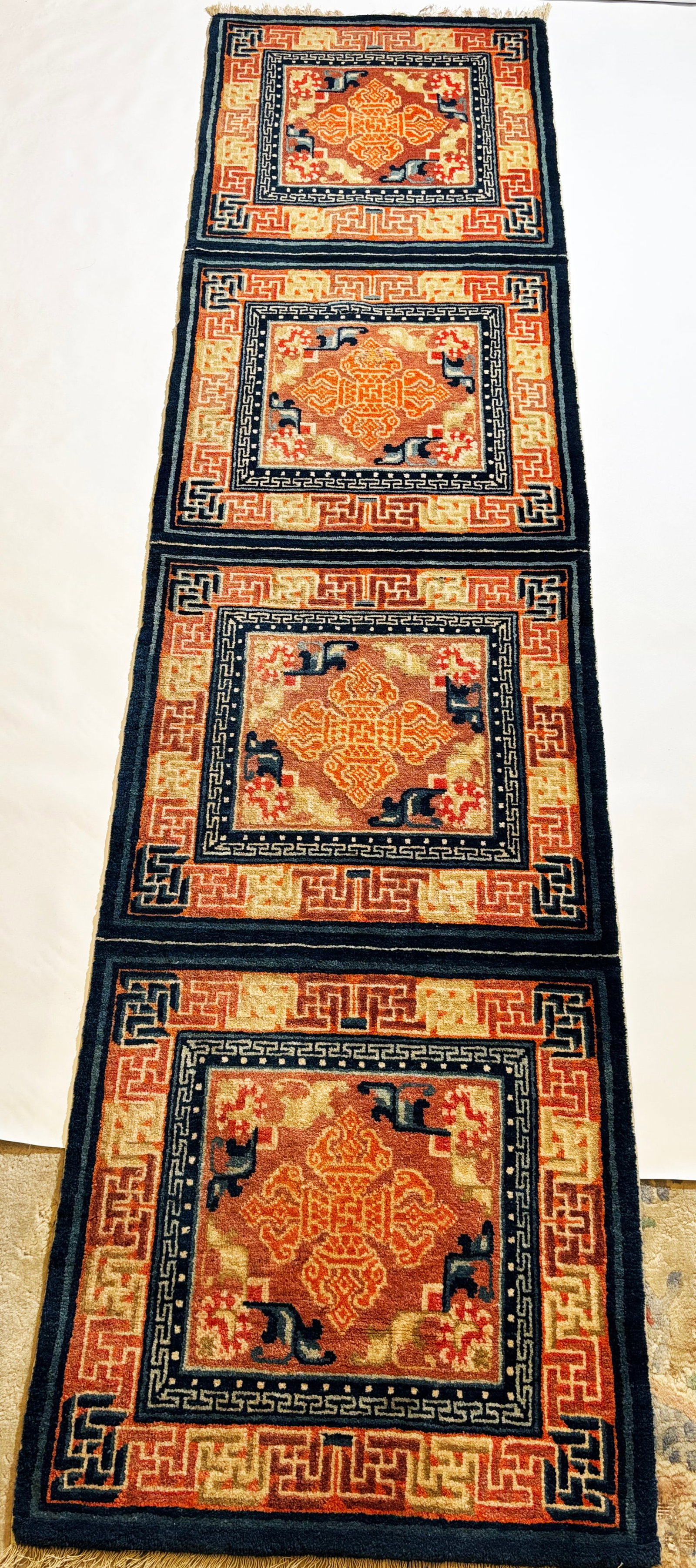Good Tibetan 4 Square Double Vajra Wool Runner: Good Tibetan 4 Square Double Vajra Wool Runner in indigos and saffrons, with short fringe to narrow ends. Length 107 inches X width 27 3/4 inches.