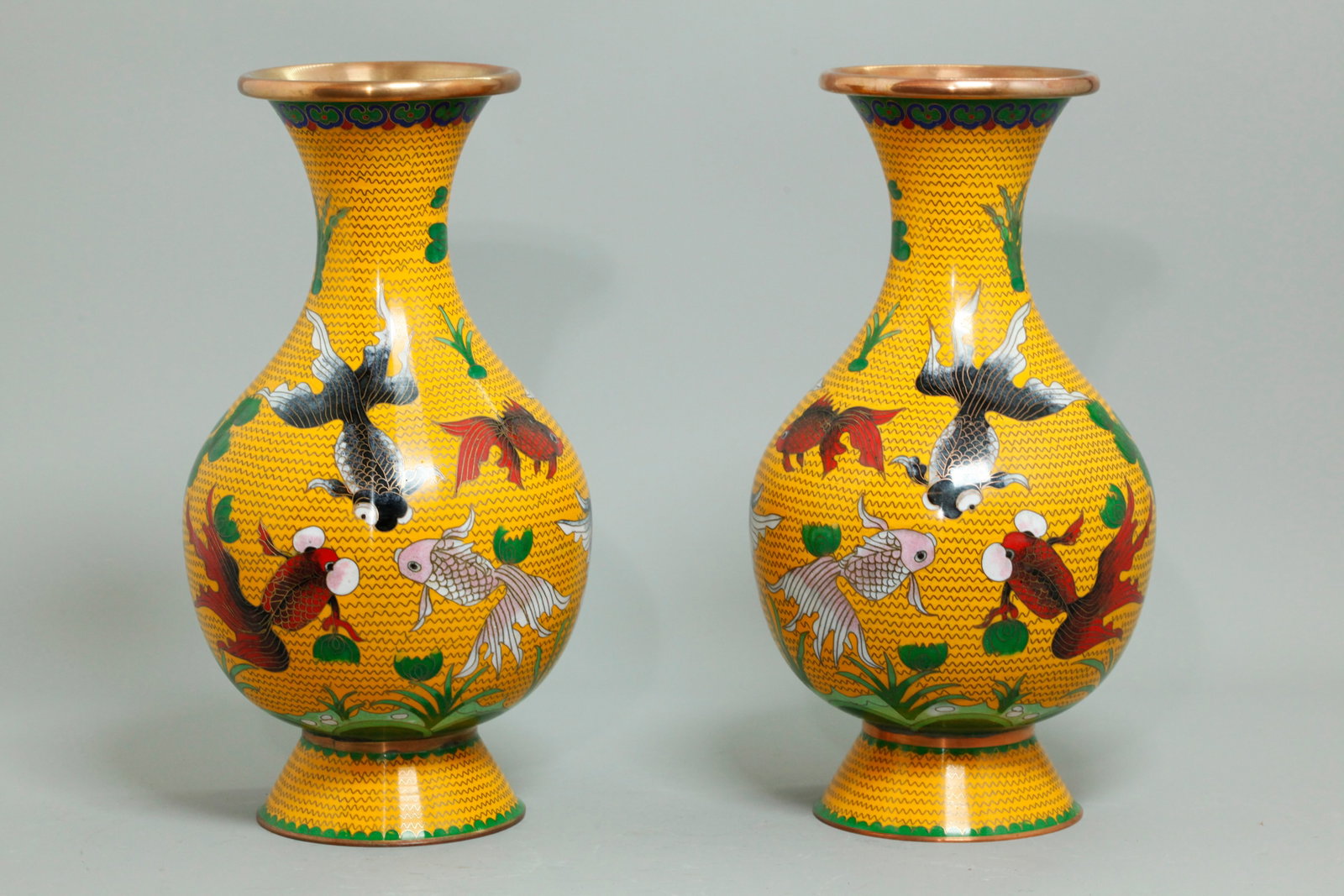 Pr Chinese Copper Alloy Cloisonne Goldfish Vases: Pr Chinese Copper Alloy & Cloisonne Goldfish Vases with gray & red fish between green water weeds all on a bright yellow ground with wave-shaped wires; the recessed flared base in turquoise enamel. He