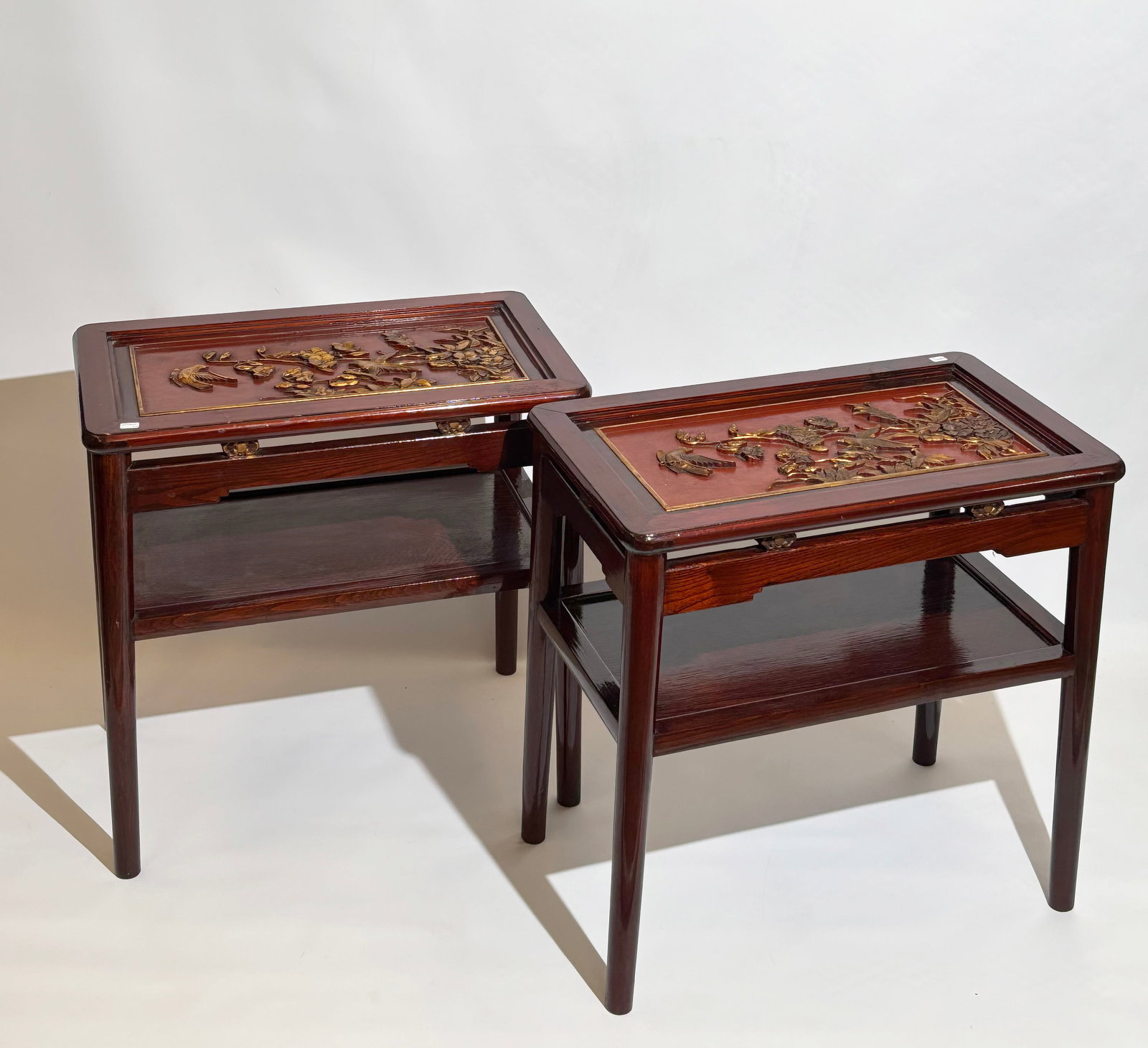 Pr Chinese Red-Lacquered Gilt-Carved Wood Tables: Pair of Chinese Red-Lacquered Gilt-Carved Wood Side Tables on 4 tube legs. The rectangular table tops feature raised gilt-carved bird-and-flower panels set against a red-lacquer ground, within thin gi