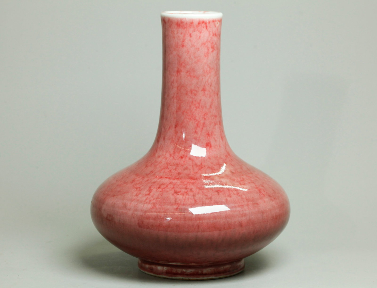 Chinese Underglaze Red Peachbloom Porcelain Vase: Chinese Underglaze Red Peachbloom Porcelain Vase, the glaze thinning at the mouth to a mottled clear line with the pink turning white at the foot ring; the base in a bubble suffused clear crackle. Hei
