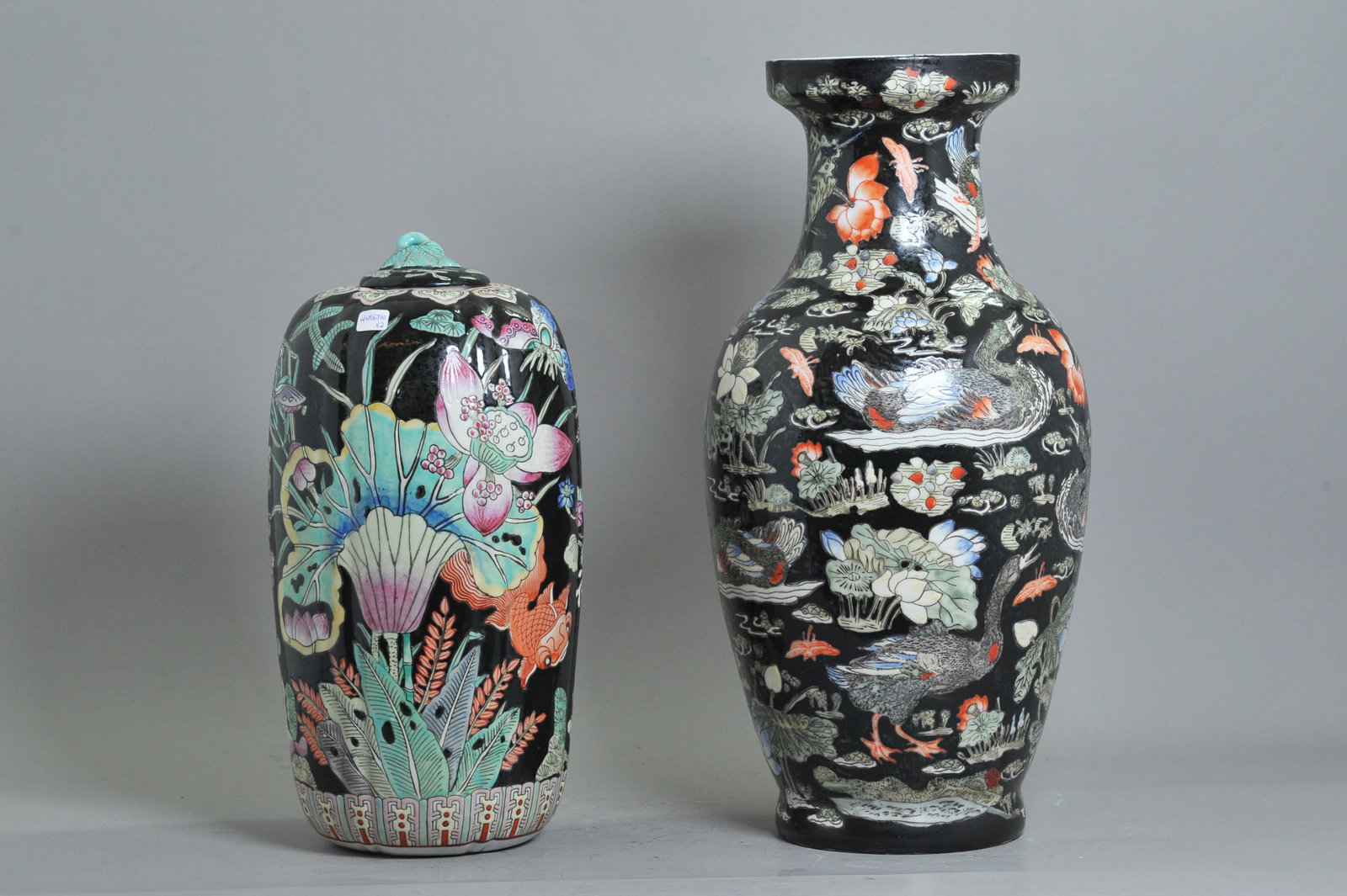 2 Chinese Famille Noire Porcelains; Vase & Jar: 2 Chinese Famille Noire enameled Porcelains with a black enamel ground; the taller, a Vase with geese and ducks in a Lotus Pond with a stamped Daoguang seal mark in iron red to the base; together with