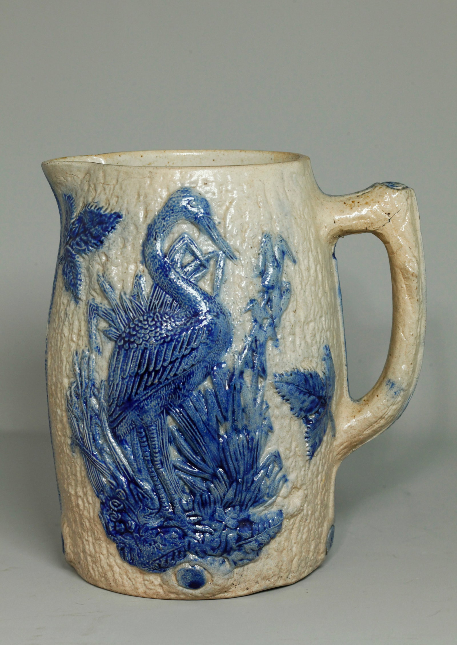 Attributed Whites Of Utica Crane & Rose Pitcher: Attributed to White's of Utica and very similar to pitchers said to be Blue Flemish Stoneware with similar cobalt Crane and Rose designs, although similar wares are found in the Ohio area from such ki