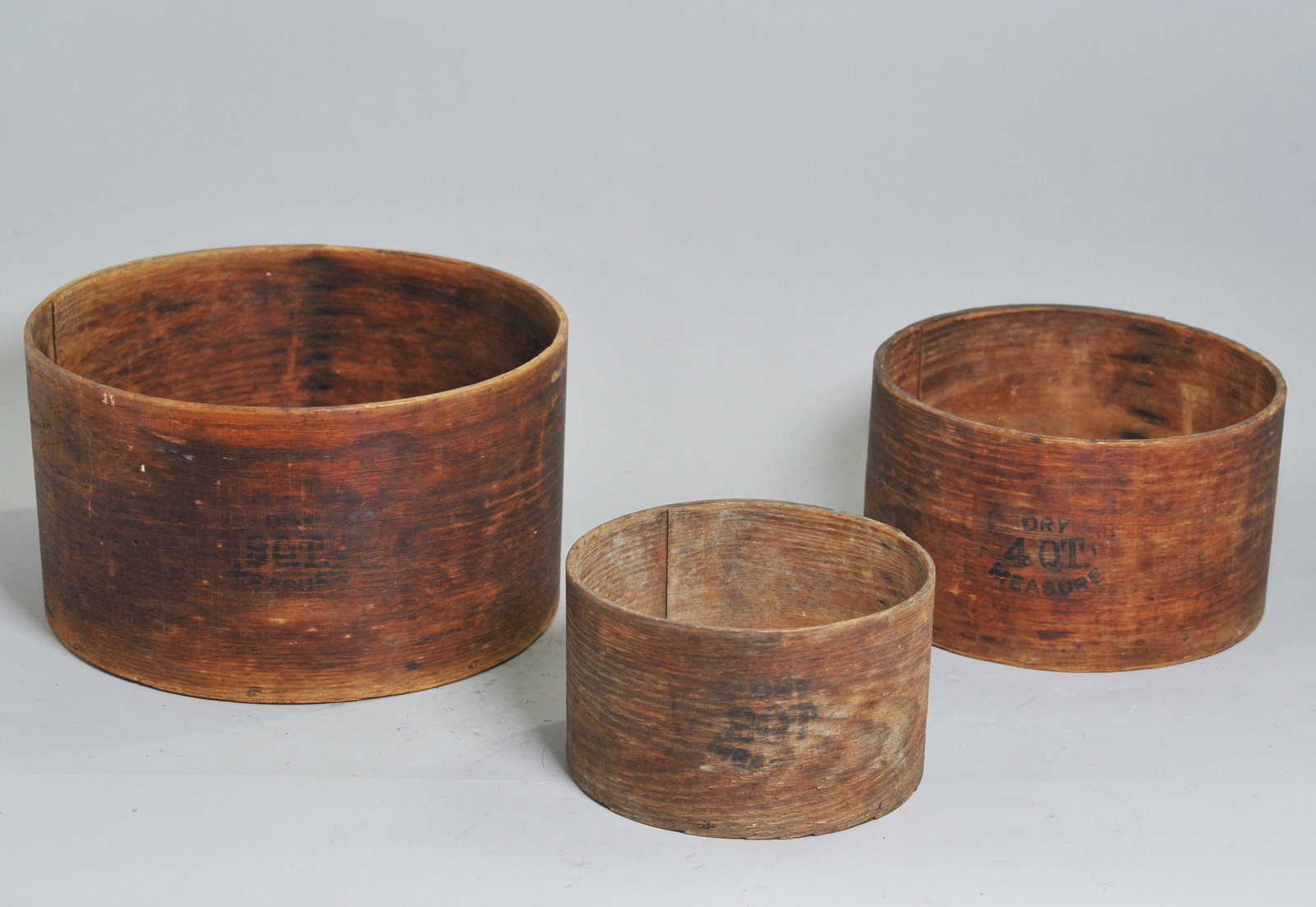 A Group of 3 American primitive Dry Measures: A Group of Three American Primitive Bentwood Dry Measures. Late 19th / Early 20th Century, E.B. Frye & Son, Wilton, New Hampshire. Comprising three nested cylindrical measures of graduated sizes, each