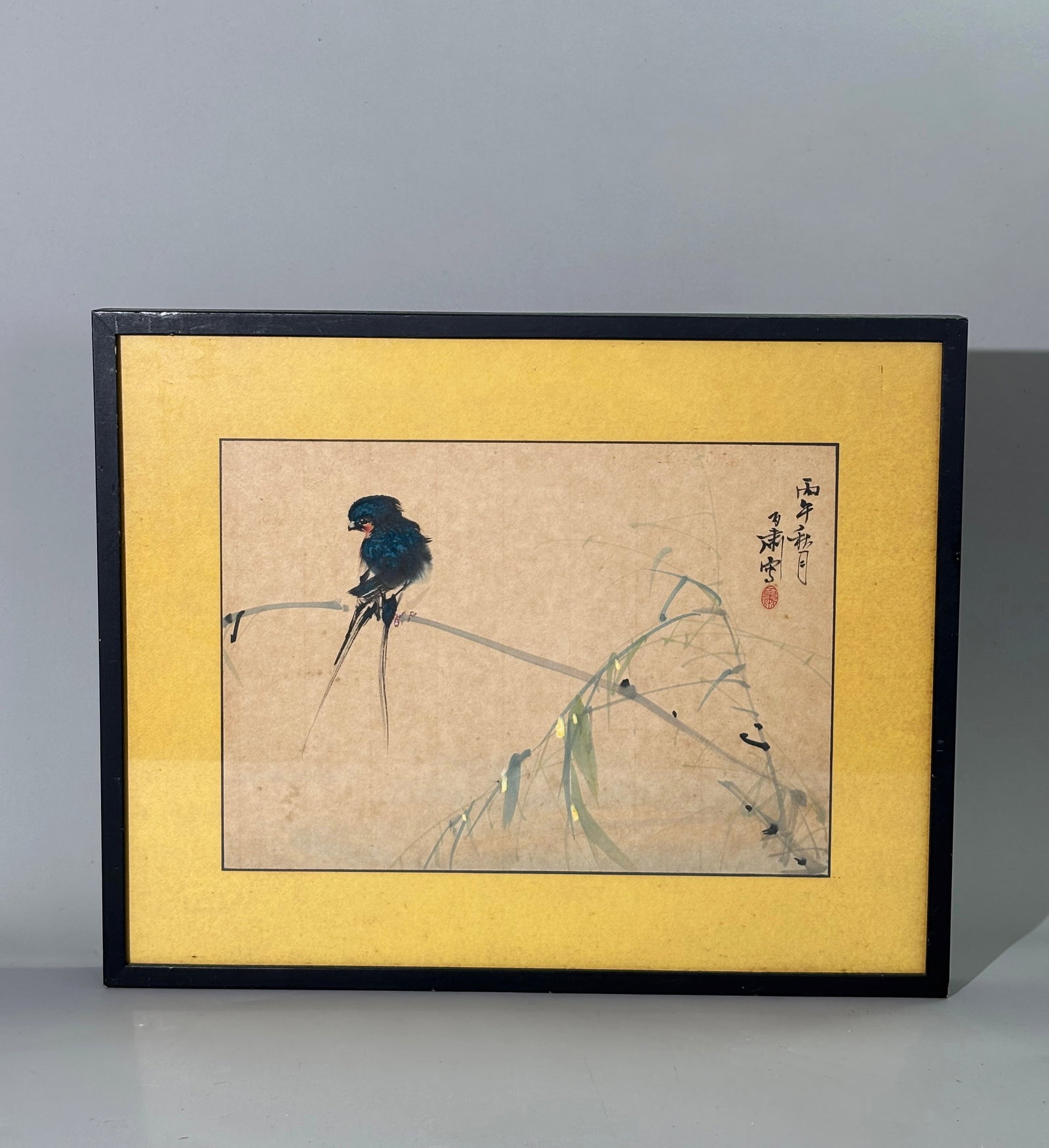 Bok Suk Wang; Chinese Painting Bird & Bamboo: Bok Suk Wang; Chinese Painting, Long Tailed Blue Bird on Bamboo, ink & color on paper signed in ink with 1 small red seal; edged in black and mounted to yellow back paper; framed to edges of yellow ba