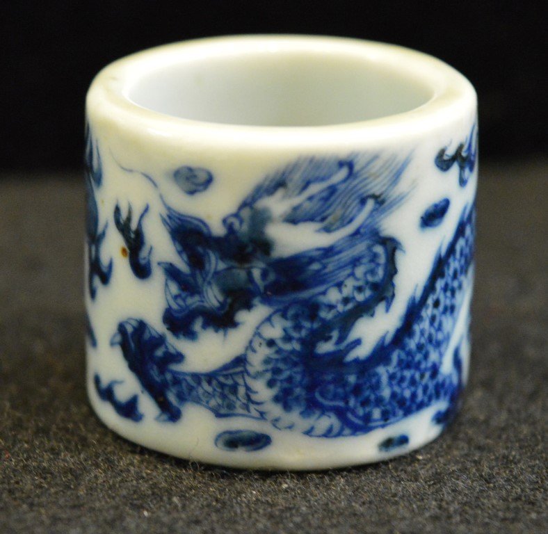 Chinese Porcelain B & W Archer's Ring: Chinese porcelain blue and white archer's ring with a 5 claw dragon chasing a pearl. Qianlong mark in underglaze blue inside. Good condition Any condition statement is given as a courtesy to a client,