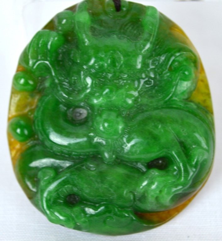 Chinese Green Jadeite Toggle with Yellow Skin: Chinese green jadeite toggle of a facing dragon, with the background in yellow jadeite. Jadeite ring on strap. Length of toggle 2 inches (5 cm) Good condition Any condition statement is given as a cou