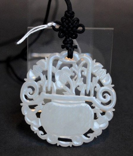 Chinese White Jade Pierced Pendant, Qing: Chinese White Jade Pierced Pendant carved as a basket of flowers on both sides, Qing Dynasty. Diameter 2 inches (5 cm.).