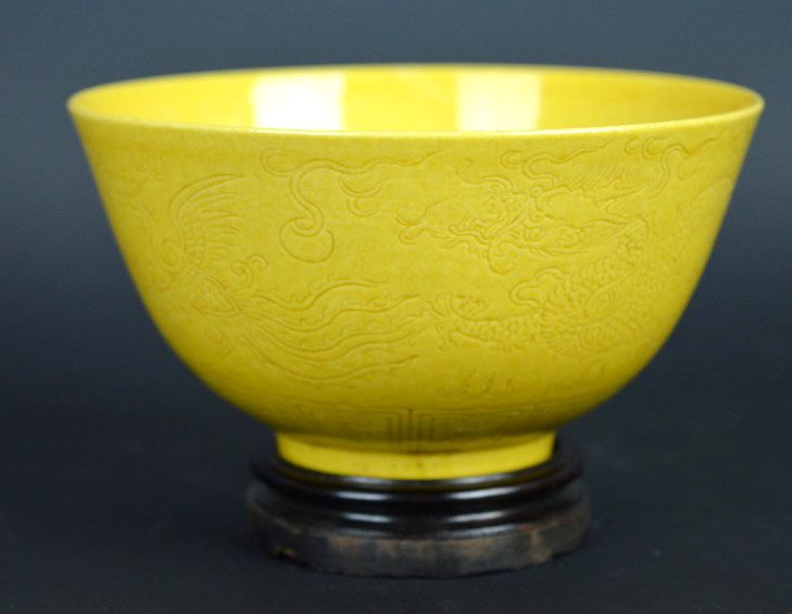 Chinese Yellow Monochrome Porcelain Bowl: Chinese Yellow Monochrome Porcelain Bowl the sides carve with a dragon and phoenix under the glaze; mark on base. Diameer 4 1/4 inches (11 cm.). Good condition.