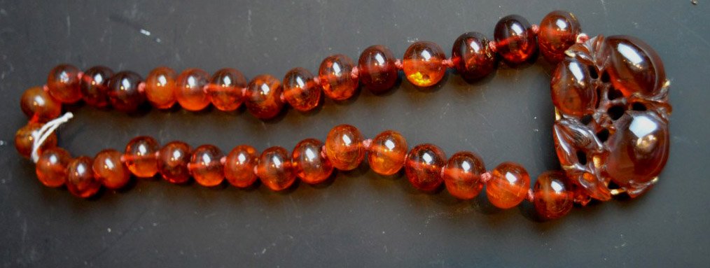 Old Chinese Carved Amber Pendant & Bead Necklace: Old Chinese Carved Amber Pendant mounted in 14K yellow gold & Bead Necklace. Open length 18 inches (46 cm.). Chips and small losses to old pendant, beads in good condition.