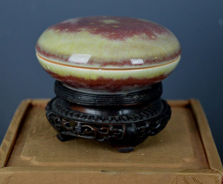 Old Chinese Porcelain Peachbloom Seal Paste Pot: Old Chinese Porcelain Peachbloom Covered Seal Paste Pot, the underglaze copper with areas of green; clear base and interior; underglaze blue mark to base. Old carved stand all in a fitted brocade Chin