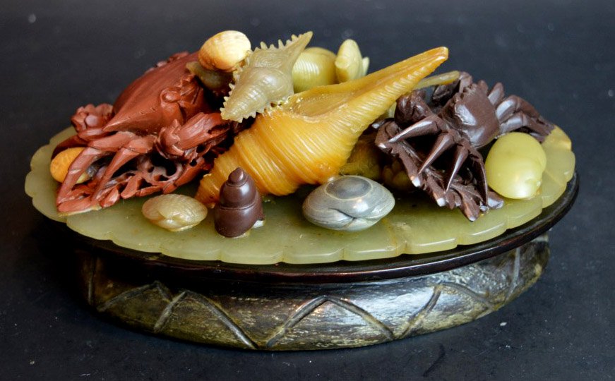 Unusual Colored Soapstone Carving Crabs & Shells: Unusual Colored Soapstone Carving of Sea Shells, crabs, fish & seaweed all on an oval platter with a further wood stand. Length of carving 8 inches (20 cm.). Good condition.