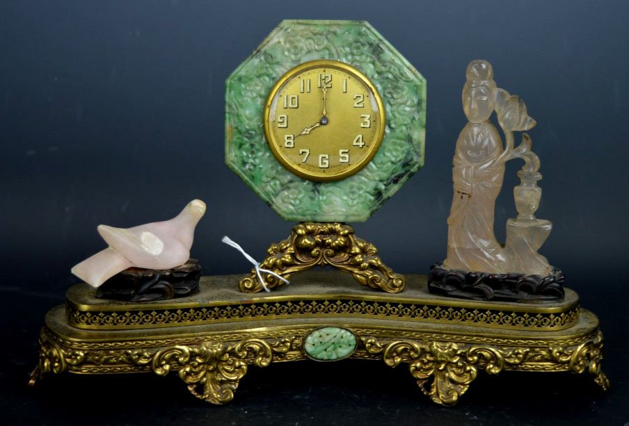 Bronze Mounted Clock with Chinese Jadeite Mounts: Bronze Mounted Clock with Chinese Jadeite Mounts including an octagon frame to the clock in jadeite, a jadeite small oval in the base and flanked by a Pink Quartz Woman and a pink stone bird both on s