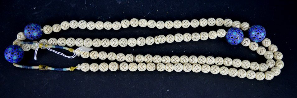 19th C Fine Chinese Carved Bone & Silver Necklace: 19th C Fine Chinese Carved Bone & Silver Necklace with each bead hollowed and carved into fretwork; separated by enameled silver beads. 101 bone beads; 4 silver spacer beads. Antique fabric covered bo