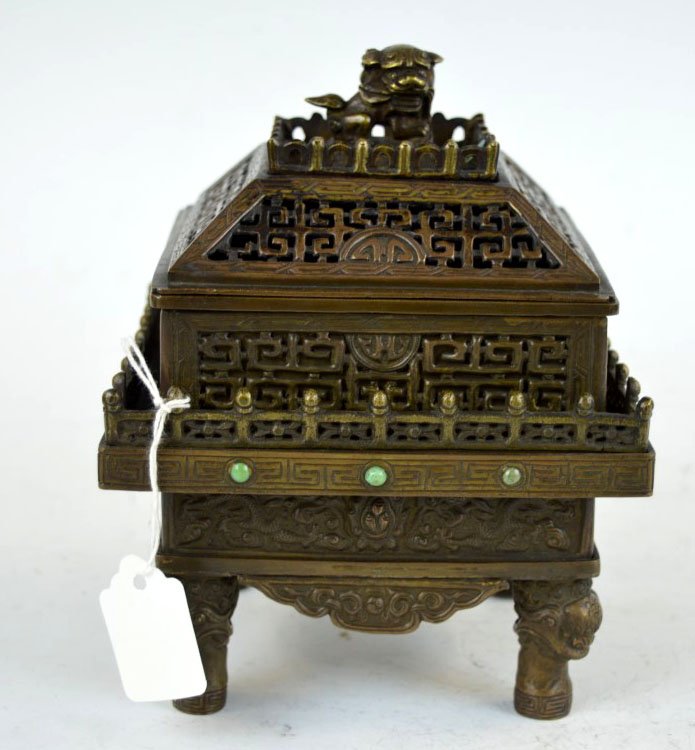 Chinese Engraved Bronze Incense Burner & Cover: Chinese Engraved Bronze 3 Part Incense Burner; pierced top with Buddhist Lion; the base with a border of engraved dragons with 4 Lion head feet. Height 7 inches (17.5 cm.).