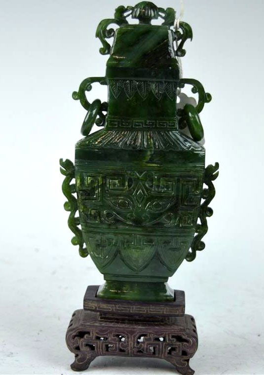 Old Carved Chinese Green Jade Vase & Cover: Old Carved Chinese Green Jade Vase & Cover in the archaic style with taotie masks, loose ring handles; with hardwood stand. Good condition, very tiny chips to top. Provenance: Old Long Island Collecti
