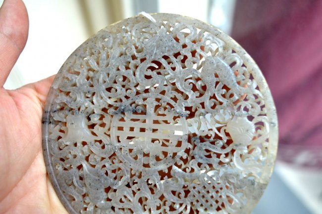 Important Chinese Carved & Pierced Jade Plaque: Important Earl 18th Century Chinese Carved & Pierced Jade Plaque with the 8 Buddhist Symbols & "Shou" Character Center; the reverse half-polished. Restored. Diameter 4 1/4 inches (11 cm.).