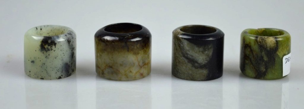 4 Qing Chinese Archer's Rings, MMA DEACCESSION: 4 Qing Chinese Archer's Rings, MMA Deaccession; 1 agate, 2 chicken bone jade, 1 yellow-green jade with brown skin flat front with Metropolitan Museum of Art: "EX COLL. MMA 1983 DEACCESSION" sticker. G