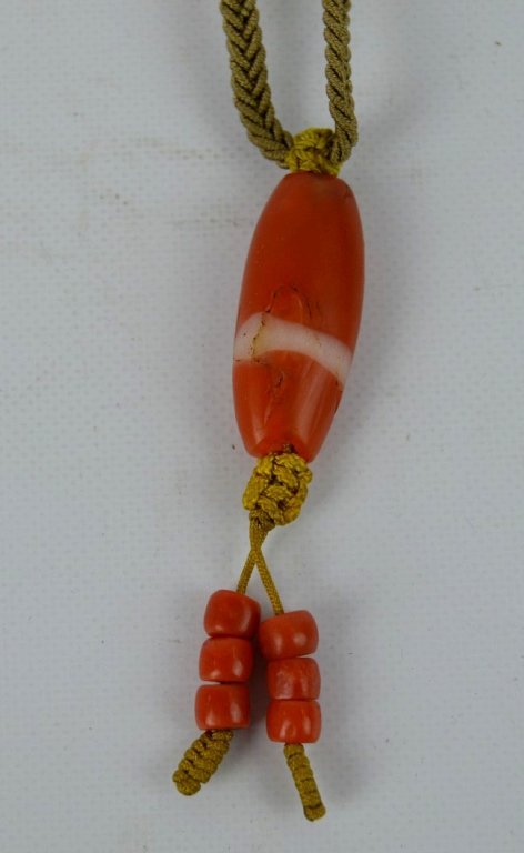 Old Tibet Carnelian Bead on Necklace Rope: Old Tibet Carnelian Bead on Necklace Rope with small coral beads. Age related wear to bead. See images for more information. Provenance: Old Long Island Collection of the Art of Tibet.