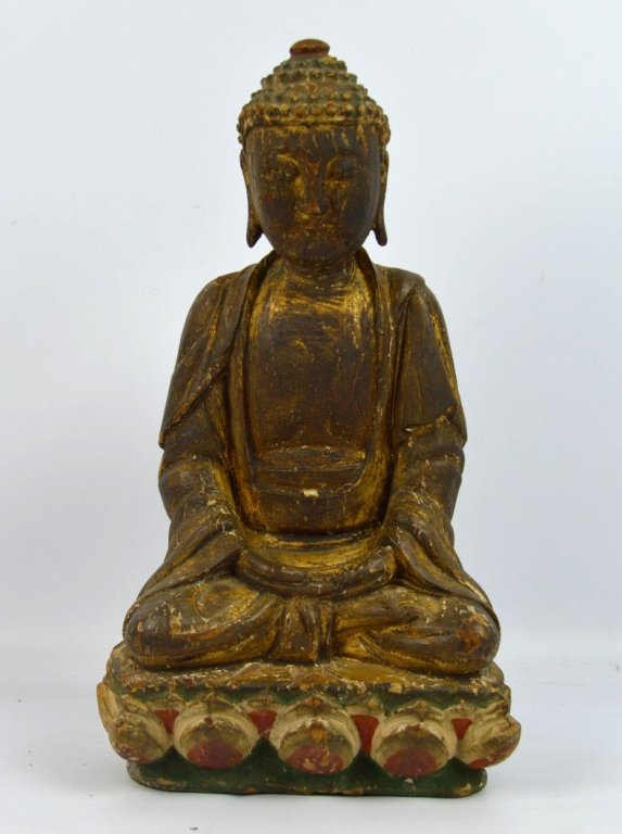 Ming or Earlier Chinese Carved Wood Buddha: Ming or Earlier Chinese Carved and gilt Wood Buddha seated on a Lotus throne in polychrome. Age related wear to wood and gilding. Height 10 inches (25.5 cm.).
