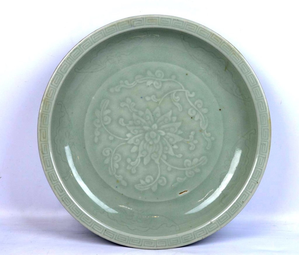 Chinese Qing Dynasty Carved Celadon Charger: Chinese Qing Dynasty Carved Celadon Charger, the inside carved with a large Buddhist Lotus surrounded by 5 carved bats and ending in an edge of cloud shapes; the base also in celadon with the foot rim