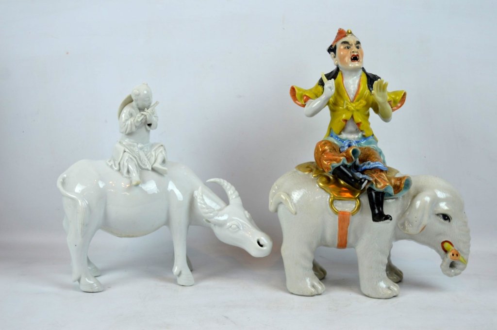 2 Chinese Enameled Immortal on Elephant & Buffalo: 2 - a Chinese Enameled Immortal on Elephant & a Blanc de Chine boy playing a flute on his Water Buffalo. The Immortal with repairs and a few small chips; the boy on buffalo with chip to right toes. He