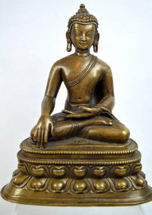 13th C Tibetan Inlaid Bronze Seated Buddha: 13th Century Tibetan Inlaid Bronze Seated Buddha, a single engraved line inscription on the top of the throne in front of his crossed legs; the eyes and hairline with small areas of silver inlay, the