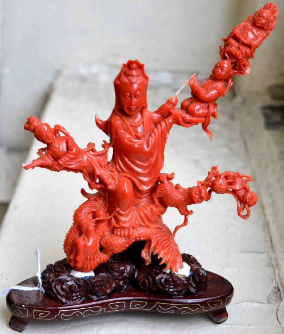 Very Fine Chinese Branch Coral Carving of Guanyin: Very Fine Chinese Branch Dark Coral Carving of Guanyin with attendants, a seated Buddha, Buddhist Lions, etc., all riding on a well carved dragon. On a custom carved and silver wire inlaid hardwood st