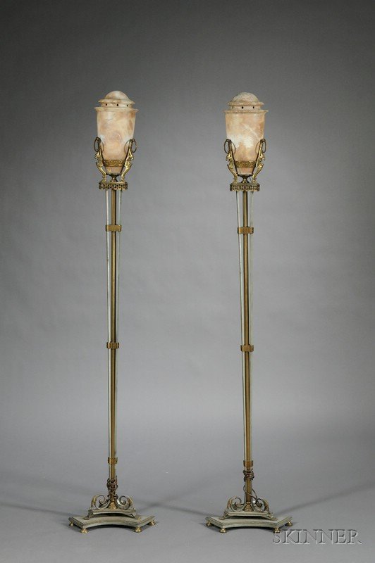 Pair of Art Deco Bronze, Steel, and Alabaster Torc: Pair of Art Deco Bronze, Steel, and Alabaster Torchieres, c. 1930, each with gray-veined and mottled brown alabaster shade with three stylized raptor supports, above slender supports on a three-sided
