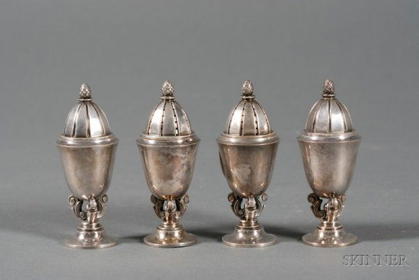 Two Pairs of Georg Jensen Sterling Salt and Pepper: Two Pairs of Georg Jensen Sterling Salt and Pepper Shakers, post-1945, no. 741, designed by Johan Rohde, urn form, with pineapple finials, vertically reeded lids, on trefoil openwork scroll base and s