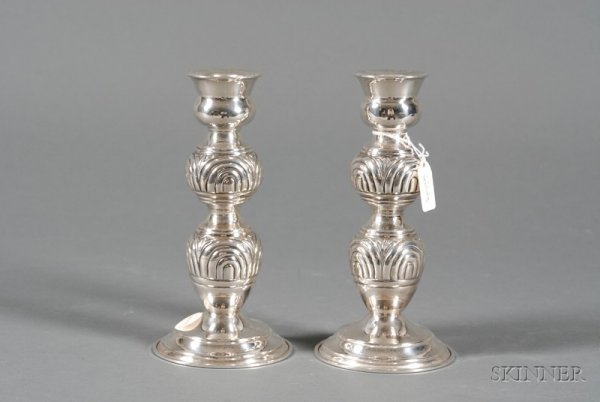 Pair of .900 Silver Candlesticks, Eastern European: Pair of .900 Silver Candlesticks, Eastern European or Middle Eastern, 20th century, plain thistle sconce of double-knopped stem, the knops molded with ribbed demilunes, on spreading foot, ht. 8 1/8 in