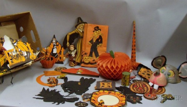 Collection of Vintage Halloween Decorations and Ac: Collection of Vintage Halloween Decorations and Accessories, including paper and tin noisemakers, a costumed monkey figure, a mask, and paper and crepe-paper decorations.