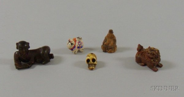 Five Netsuke, kitten, skull, reclining reading fig: Five Netsuke, kitten, skull, reclining reading figure, foo dog, and a seated figure.