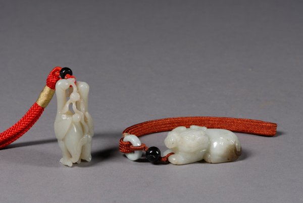 Two Jade Pendants, China, 18th/19th century, a pai: Two Jade Pendants, China, 18th/19th century, a pair of geese with a ling chih fungus and a foo dog, each approx. ht. 2 in.