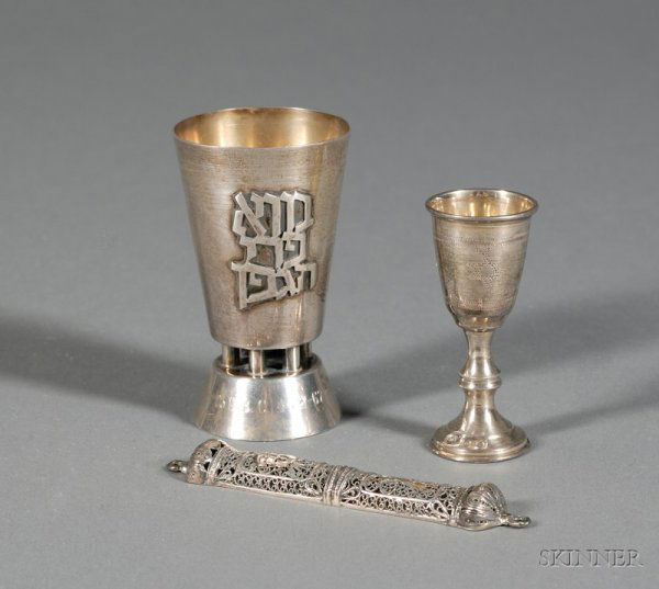 Two Silver Kiddush Cups and a Silver Filigree Mezuz: Two Silver Kiddush Cups and a Silver Filigree Mezuzah, comprising an English kiddush cup, London, 1927, maker's mark MP, engraved with Star of David band, ht. 3 1/4, an Israeli filigree mezuzah, lg. 5