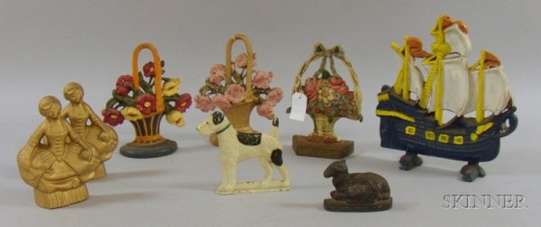 Eight Painted Cast Iron Doorstops, three baskets o: Eight Painted Cast Iron Doorstops, three baskets of flowers, a terrier, a pair of belles, a sailing ship, and a small recumbent sheep with lamb.